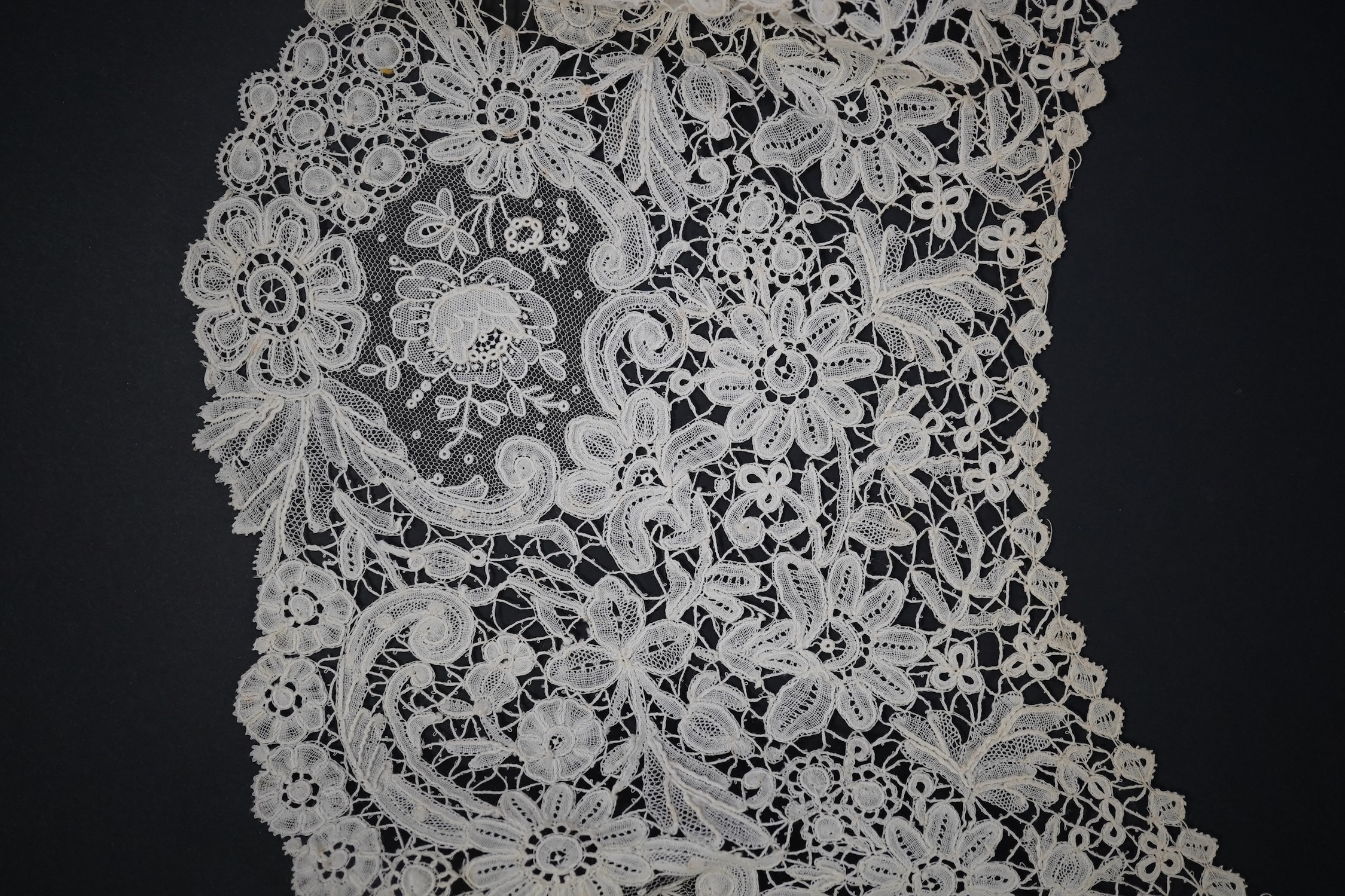 An 1860’s unused, large circular flounce shaped collar of mixed Brussels bobbin lace, with twelve needle lace Point de Gaz insertions, 18.5cm deep, approximately 248cm along bottom, edge. Condition - good